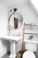 Bath Room, Two Piece Toilet, Wall Lighting, and Pedestal Sink A bathroom with  a Kohler Brockway sink.  Photos from Before & After: An A-Frame Cabin Boasts Serious Scandinavian Vibes