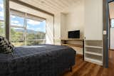 The bedroom with built-in storage along the wall.