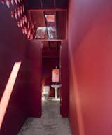 Bath Room, Two Piece Toilet, and Pedestal Sink A bathroom with red walls and ceilings.  Photo 5 of 60 in Corridor by Casey Tiedman from A Bright Red Island Residence Embraces a Linden Tree