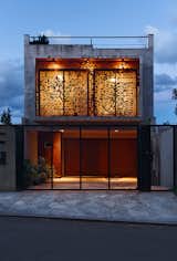 A highly transparent metal gate serves as the entrance to the garage.