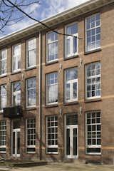 Exterior, Apartment, Brick, and Gable A school in Rotterdam that was built in 1912 was converted into six apartments.  Exterior Gable Apartment Photos from A 20th-Century Dutch Schoolhouse Now Holds a Series of Airy Lofts