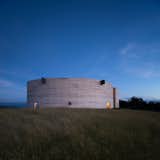 The 2,000-square-feet house has an enigmatic form that resembles a cylinder that's been cut in half along its diameter.