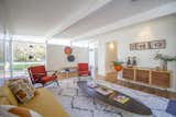 Living, Console Tables, Sofa, Chair, Coffee Tables, Rug, Medium Hardwood, End Tables, Floor, and Wall A lounging den with bright pops of color.  Living Floor Chair Console Tables Rug Wall Photos from A Meticulously Updated Midcentury in L.A. Asks $1.49M