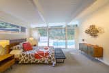 Bedroom, Table, Bench, Bunks, Lamps, Bed, Carpet, Storage, and Night Stands The owners can access the pool in the backyard via sliding doors in the master bedroom.  Bedroom Storage Lamps Bunks Bench Photos from A Meticulously Updated Midcentury in L.A. Asks $1.49M