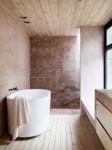 The terracotta latticework structure is used for the walls of the bathroom.