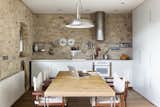 The original 16th-century stone walls are left exposed in the kitchen.
