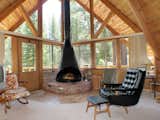 Living Room, Chair, Carpet Floor, and Hanging Fireplace A South Lake Tahoe A-frame with a wood-burning fireplace.  Photo 8 of 11 in Stretch Your Travel Budget With These Cool Rentals—All Around $100 or Less