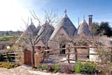 Exterior, Stone Siding Material, House Building Type, and Cabin Building Type A traditional trullo home in the town of Cisternino in Italy's Puglia region.  Photos from Stretch Your Travel Budget With These Cool Rentals—All Around $100 or Less