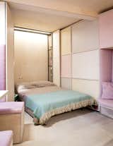 A hidden Murphy bed is located along the narrowest wall of the triangular-shaped apartment.