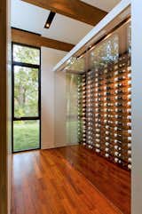 Storage Room A glass encased wine storage system lets the owners and their guests select a bottle with ease.  Photo 9 of 16 in This Glass House and "Shiny Shed" Merge With Nature in Minnesota