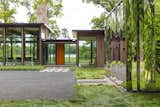 Exterior, Metal Roof Material, Wood Siding Material, Metal Siding Material, Glass Siding Material, Flat RoofLine, and House Building Type A shiny mirror-clad shed greets guests as they approach the house.  Photo 1 of 16 in This Glass House and "Shiny Shed" Merge With Nature in Minnesota
