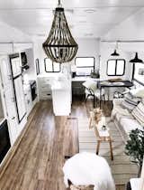Wood details and a simple, white-and-black color scheme give the RV's interior a bright, modern, Scandinavian feel.