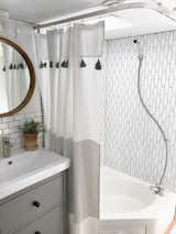 Bath Room, Track Lighting, Subway Tile Wall, Corner Shower, and Drop In Sink A renovated bathroom with a new showerstall and tiled wall.  Photo 9 of 16 in Hit the Road With This Chic Camper on Sale For $28K