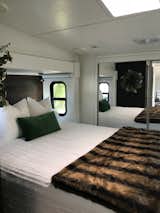 Bedroom, Bed, Wardrobe, and Ceiling Lighting A skylight window illuminates the bedroom, which appears larger than it is because of the closet with mirror-clad sliding doors.  Photo 6 of 16 in Hit the Road With This Chic Camper on Sale For $28K