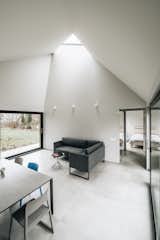 Fully glazed walls on two sides and a triangular skylight allow light to permeate the living areas.