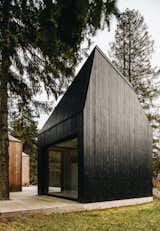 The sauna cabin bears a coat of black tar.