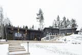 Located on a rocky seaside plot in Inkoo, Finland, this family home designed by architect Katja Jämsä was built with 204-millimeter wide Honka Fusion non-settling laminated timber, and includes large glass windows and doors.