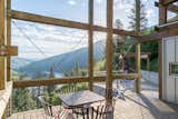 Outdoor, Large Patio, Porch, Deck, Side Yard, Wood Fences, Wall, Grass, and Trees The living area opens to an expansive outdoor deck that frames river views.  Photos from Own This Award-Winning Riverside Home in Idaho For $650K