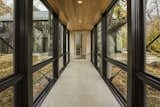 A fully glazed corridor allows the owner to enjoy the autumn foliage outdoors.