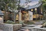 The home is composed of limestone masonry and structural steel accents.