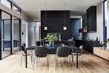 The simple and stylish dining set complements the dark kitchen.


