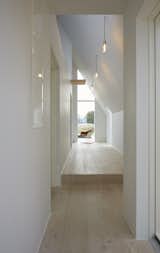 Pale wooden floors and white walls brighten the interior of the home.