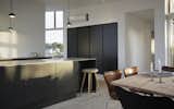 A dark, streamlined kitchen in the open-plan living area.