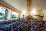 Recessed lighting is a great bedroom lighting idea for a low ceiling, as shown in this cozy sleeping loft with a double bed.