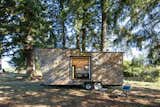 Exterior, Tiny Home Building Type, Camper Building Type, Wood Siding Material, and Flat RoofLine A custom rock wall system that takes care of the couple's shared passion for bouldering.  Photo 4 of 10 in Off The Grid by Carl Kruse