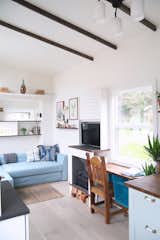 Office, Study Room Type, Light Hardwood Floor, Desk, and Chair Impola and his team used wideplank distressed oak for the floors.  Photo 5 of 11 in This Tiny Trailer Home Boasts Soothing Beach Vibes