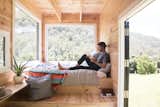 Bedroom, Shelves, Light Hardwood Floor, and Bed Unyoked offers four tiny houses in Sydney, and two in Melbourne that are both set in thoughtfully chosen sites of natural beauty.  Photo 13 of 20 in 10 Adorable Tiny Homes You Can Rent Right Now