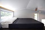 In the loft, a full size mattress is set parallel to the length of the house.&nbsp;