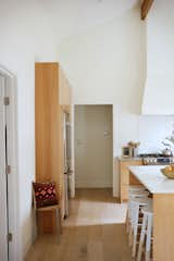 Stained hardwood floors compliment the stained beech wood cabinets.