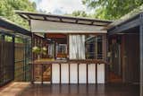 Outdoor, Wood Fences, Wall, Large Patio, Porch, Deck, and Trees The vertical Japanese slat details imbue the house with a Japanese, Zen-inspired aesthetic.  Photo 6 of 17 in This Brisbane Home For Sale Is a Lush Sanctuary