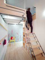 From the alcove playroom, a ladder leads up to a mezzanine loft with a double bed and two single bed.