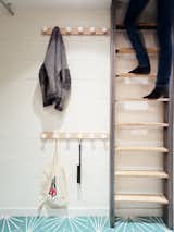 Staircase and Wood Tread Toys and coats are stored in the playroom, to keep the rest of the home neat and tidy.  Photo 9 of 13 in This Compact Home in Paris Has Nearly 70 Concealed Closets