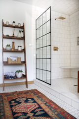 Bath Room, Open Shower, Ceramic Tile Floor, Rug Floor, Corner Shower, and Subway Tile Wall With this timeframe as a challenge, Bertolini did a full overhaul of the house’s old bathroom.  Photos from Before & After: An Outdated Bathroom Gets a Complete Makeover in Just 6 Weeks
