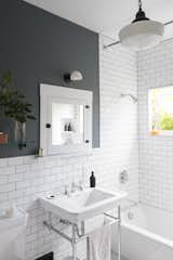 Bath, Soaking, Wall Mount, Pendant, Two Piece, Subway Tile, and Wall White subway tiles and dark grout give the new bathroom a crisp, clean look.  Bath Two Piece Pendant Photos from Before & After: A DIY Couple Tackle Their 1915 Craftsman in San Diego