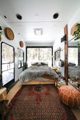 Bedroom, Bed, Ceiling Lighting, and Rug Floor Autumn and Rusty’s bedroom is a space where the couple can relax and recharge after a long day.  Photo 6 of 11 in A Couple Transform a Toy Hauler Into a Mobile Tiny Home For $6K