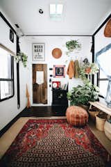 Living Room, Ottomans, Bench, Dark Hardwood Floor, and Rug Floor Bailey decorated the toyhauler with a handmade Persian rugs, which she bought on eBay for $99 each, some poufs, woven flat baskets that she “borrowed” from her mother.  Search “수원건마【【달밤】】수원건마≤≤MAB99。com≥≥시작 수원건마 수원아로마 수원건마ꌳ수원OP 수원유흥 수원건마ᗏ수원안마” from A Couple Transform a Toy Hauler Into a Mobile Tiny Home For $6K