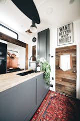 Kitchen, Ceiling Lighting, Rug Floor, Wood Counter, and Undermount Sink “I wanted a blank slate that was versatile so I could switch it up, and change things around as we all grew in our tiny space,” she says  Photos from A Couple Transform a Toy Hauler Into a Mobile Tiny Home For $6K