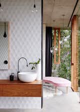 Bath Room, Concrete Floor, Vessel Sink, Wood Counter, and Pendant Lighting The glazed vertical panels have fine, black silicone lines that define the joints, and solid rosewood frames around the operable windows.  Photos from A Funky, Curvaceous Rainforest Home in Australia Hits the Market