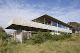 Exterior, Concrete Siding Material, House Building Type, Beach House Building Type, and Flat RoofLine The house is split into three levels.  Photos from A Concrete Abode in Uruguay Embraces its Beachfront Setting