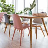 An up-close look at the dining table from Maisons du Monde, a pink dining chair from Habitat, and a black dining chair from Muuto.