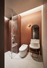Bath, Porcelain Tile, Vessel, Open, Wall, One Piece, and Corner A deep vessel sink sits peacefully in this copper-hued bathroom.   Bath Corner One Piece Porcelain Tile Photos from Vintage and Industrial Elements Combine in an Updated Taiwan Apartment