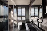 Bath Room, Enclosed Shower, Slate Floor, One Piece Toilet, Stone Tile Wall, Recessed Lighting, Vessel Sink, and Concrete Wall Gray plaster was used for the walls.  Photos from Vintage and Industrial Elements Combine in an Updated Taiwan Apartment