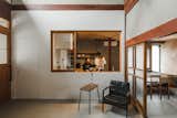 Kitchen, Concrete Floor, Wood Cabinet, and Concrete Backsplashe Glass takes the place of paper in the shoji screen-style doors that close and open to separate and connect the different functional zones.  Photos from Before & After: An Old Japanese Farmhouse Gets a Modern Facelift