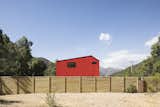 Small Home, Exterior, Prefab, House, Metal, Saltbox, and Metal Assadi says that the color red is commonly used for homes in this part of Chile.  Exterior Prefab House Small Home Photos from This Modular Home in Chile Has Us Seeing Red—in a Good Way