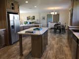 Kitchen, Ceiling Lighting, Refrigerator, and Wood Cabinet Interiors of a prefab home by D&amp;W Homes.  Photo 2 of 4 in 4 Companies to Know If You're Building a Prefab Home in Ohio