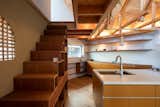 Kitchen, Light Hardwood Floor, Pendant Lighting, Open Cabinet, Cooktops, and Undermount Sink On the second level is a large open plan living, dining and kitchen to the left of the stairs.  Photo 8 of 17 in This Whimsical Home in Japan Encourages Play and Exploration